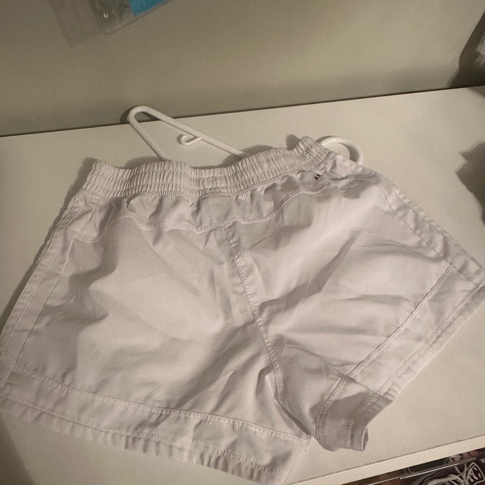 Adidas white athletic shorts. These shorts are in a size XS